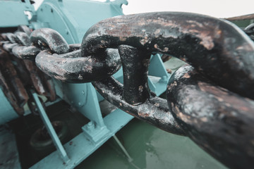 Marine anchor chain close-up and winding mechanism. Selective focus on one chain link. Horizontal. © Vladimir Kazakov