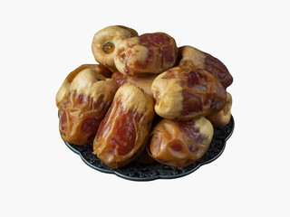 Isolated Saudi dates Sagai in a bowl. Top view