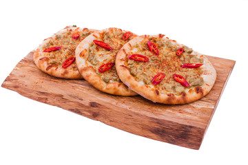Three Pizza with curry sauce, meat, red pepper on a wooden background. The object is isolated on a white background.