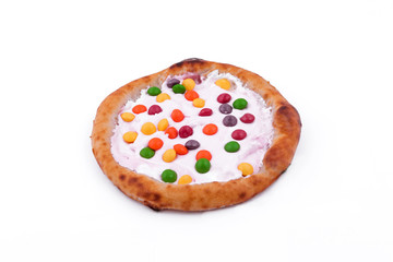 Sweet pizza with marshmallow sauce and colored sweets on a white background