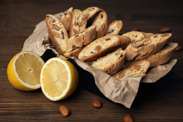 Homemade Italian cookies cantuccini with almond seeds in metal box on brown crumpled paper