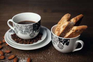 Homemade Italian cookies cantuccini, cup of coffee and almond seeds