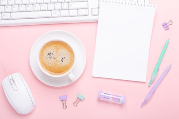 Obraz na płótnie Canvas Woman office workplace with cup of coffee, notepad and stationery accessories on pink background. Top view