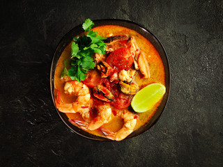 traditional tom yam soup. Fashionable and modern Asian cuisine. top view of spicy shrimp and broth. copy space for your layout.