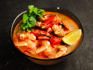 traditional tom yam soup. Fashionable and modern Asian cuisine. Close-up photo of spicy shrimp and broth.