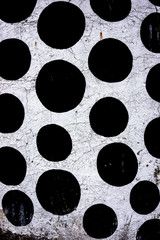Wall of black polkadots on white background