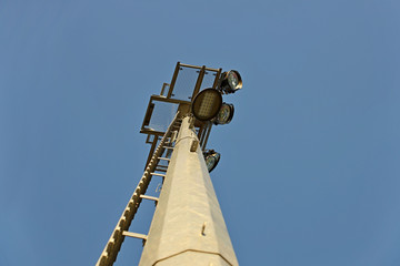 Ice lamps for outdoor lighting of a large territory located on a high aluminum pole. Bottom view of the modern lighting of the football field and sports stadium. Technological progress in lighting