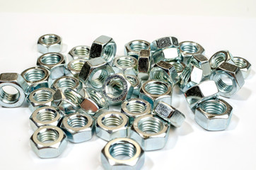 metal nuts on a white background. close-up