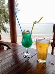 blue lagoon cocktail and a glass of beer