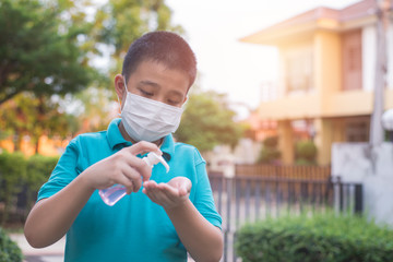 Asian children wear mask and squeeze alcohol gels. To clean hands, prevent coronavirus COVID-19 or PM2.5. Health care concepts.