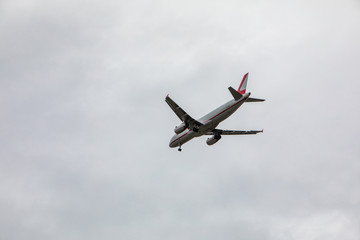 plane in sky landing overcast weather