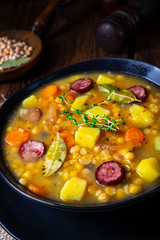 Rustic pea soup with bacon and sausages