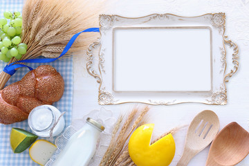Top view photo of dairy products over white background. Symbols of jewish holiday - Shavuot