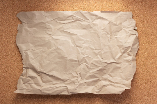 Wrinkled Or Crumpled Paper At
Cork Board Background