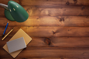 notepad or paper notebook and lamp at wooden table