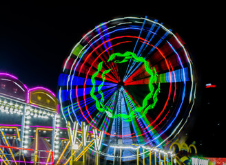 Night View of Amusement park rides, Ferris Wheel in diwali fair
