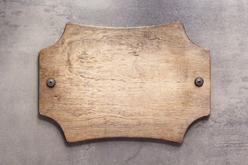 wooden nameplate or wall sign at  concrete background