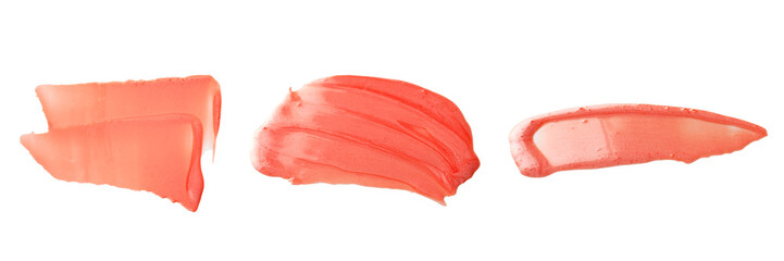 Texture and stroke of red lip gloss on a white background.