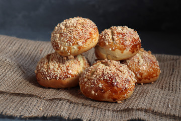 Bread rolls on dark rustic background, on burlap.