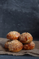 Bread rolls on dark rustic background, on burlap.