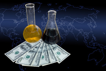 Prices of crude oil and fuel concept image. Chemical retorts with dark and light liquids inside and...