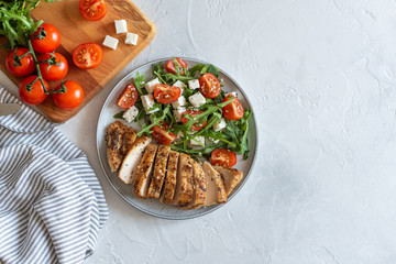 Close-up on a salad with chicken and tomato