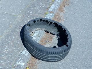 Remains of exploded tyre seen at the roadside.