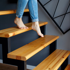 Woman in blue jeans go down in stairs. © Dmitrii Kotin