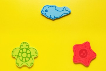 flatlay toys on a yellow background. Marine life.Mockup for design with copy space.