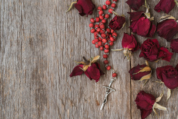 Rosary and dry roses