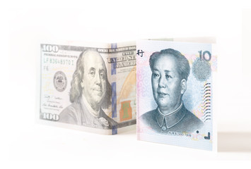 Chinese Yuan Note and united states of america U.S. dollar on white background, Trade wars and relationship between the two countries concept, selective focus on Chinese Yuan Note