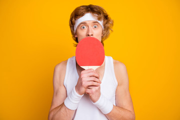 Close-up portrait of his he nice attractive puzzled confused guy holding in hands ping pong racket...