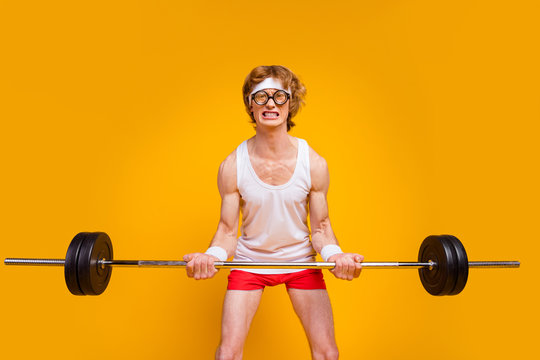 Portrait of his he nice attractive weak slim sad desperate guy lifting heavy barbell doing enduring work out isolated over bright vivid shine vibrant yellow color background
