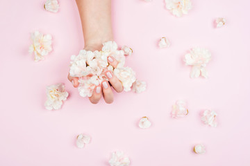 Fototapeta na wymiar Delicate female manicure on a pink background