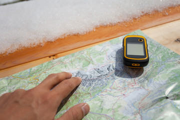 a trekker using a gps during his trip in the mountain