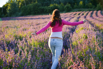 Girl runs free through purple lavender field in the south of France.