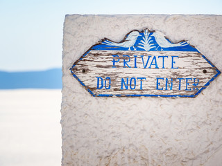 Fototapeta premium Wooden sign with lettering dont enter, private. Santorini, Cyclades, Greece.