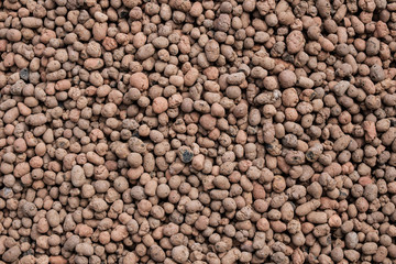 Top view on a seamless abstract background from expanded clay. Flat lay.