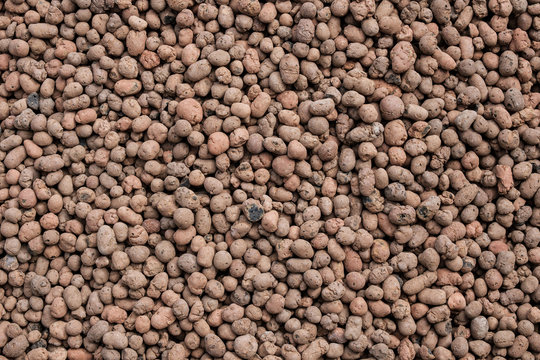 Top view on a seamless abstract background from expanded clay. Flat lay.