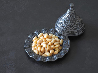 Pine nuts on the black table.
