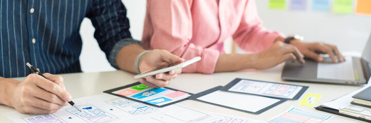 Graphic designers team work together with UX UI designer planning application template layout...