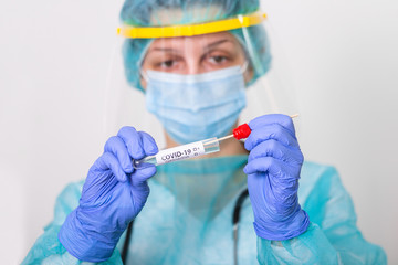 Lab technician holding swab collection kit,Coronavirus COVID-19 specimen collecting equipment,DNA nasal and oral swabbing for PCR polymerase chain reaction laboratory testing procedure and shipping