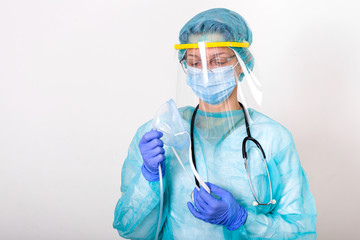 Doctor holding up oxygen mask as if to put on patient in hospital, Healthcare workers in the Coronavirus Covid19 pandemic in protective equipment put on oxygen mask patient diagnosis of coronavirus