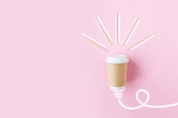 eco disposable glass of coffee idea lamp on pink background. Bulb light symbol energy. Business s Icon with black coffee. Coffee shop concept. Hot drink.