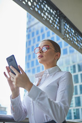 Fototapeta premium Real estate agent talking on the phone. in the background modern buildings, office buildings