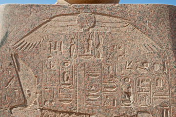 Hieroglyphic carvings on an ancient egyptian temple wall