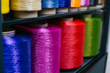 Big colored spool roll of synthetic thread for carpet