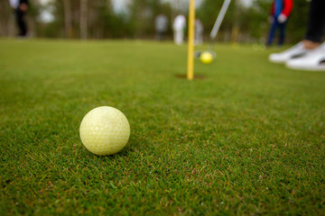 Playing golf on the green and during training