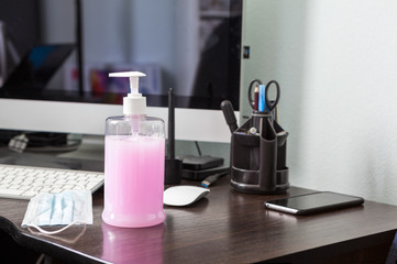 Fototapeta na wymiar Liguid alcohol sanitizer standing on working desk, gel for hands antibacterial cleaning and hygiene from virus, nobody