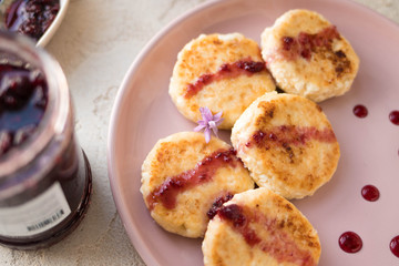 Breakfast, roasted cheesecakes with red jam, close-up photo